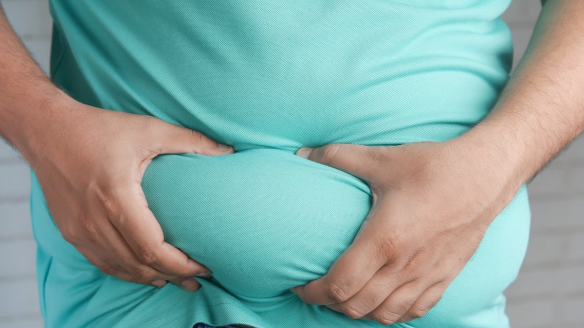 a man holding his stomach with his hands